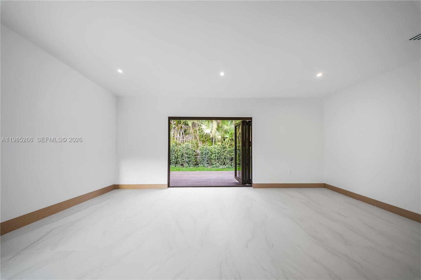 4241 Red Road Coral Gables, FL 33146 - Photo 37 of 51 a view of an empty room with wooden floor and a window