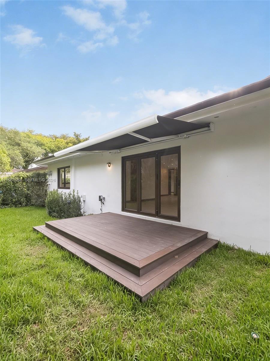 4241 Red Road Coral Gables, FL 33146 - Photo 39 of 51 a view of a house with a yard and wooden fence