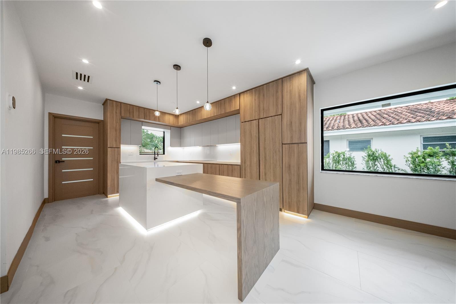 4241 Red Road Coral Gables, FL 33146 - Photo 10 of 51 a kitchen with stainless steel appliances kitchen island granite countertop a refrigerator and a sink