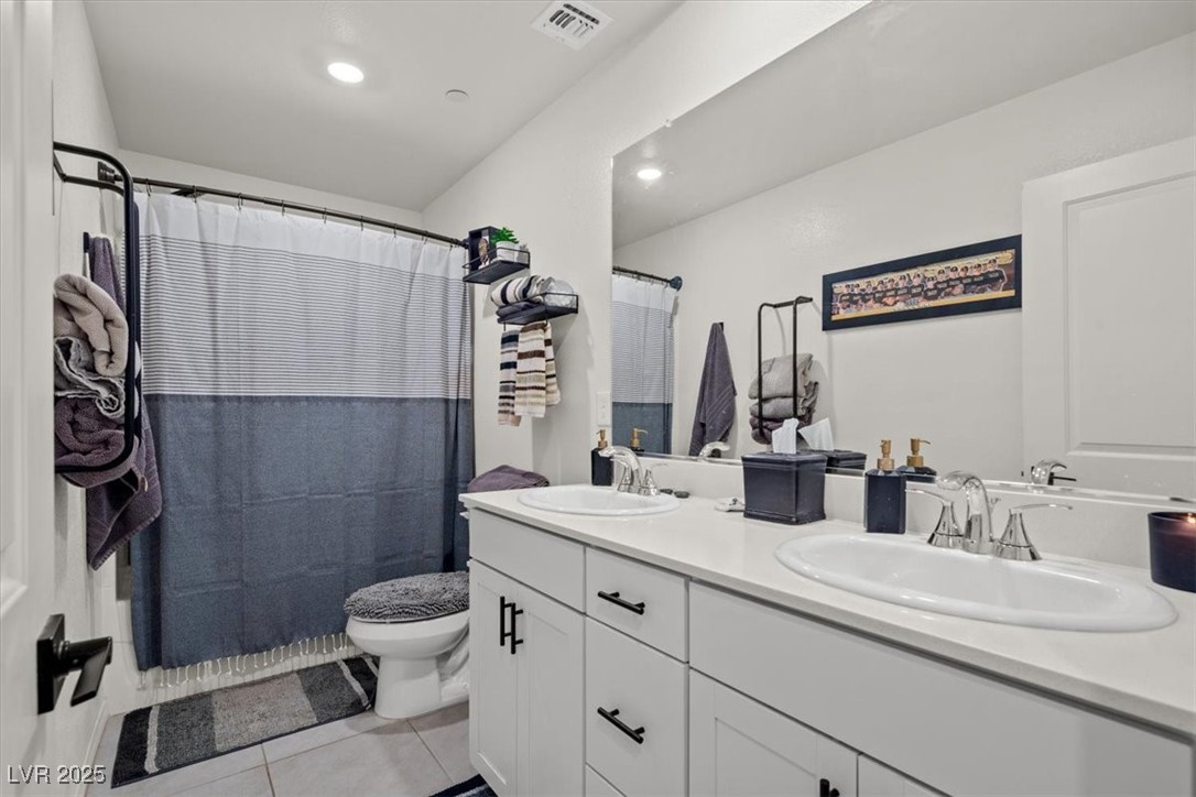 9775 Free Rappel Avenue Las Vegas, NV 89166 - Photo 37 of 51 Bathroom with light tile patterned flooring, double vanity, recessed lighting, and curtained shower