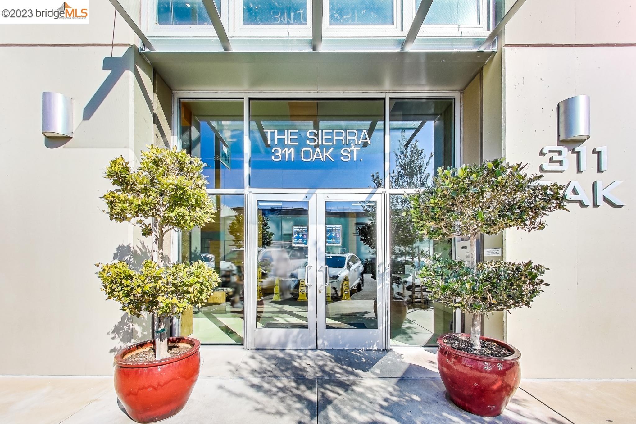 311 Oak Street, Unit 730 Oakland, CA 94607 - Photo 12 of 21 a potted plant sitting in front of a glass door