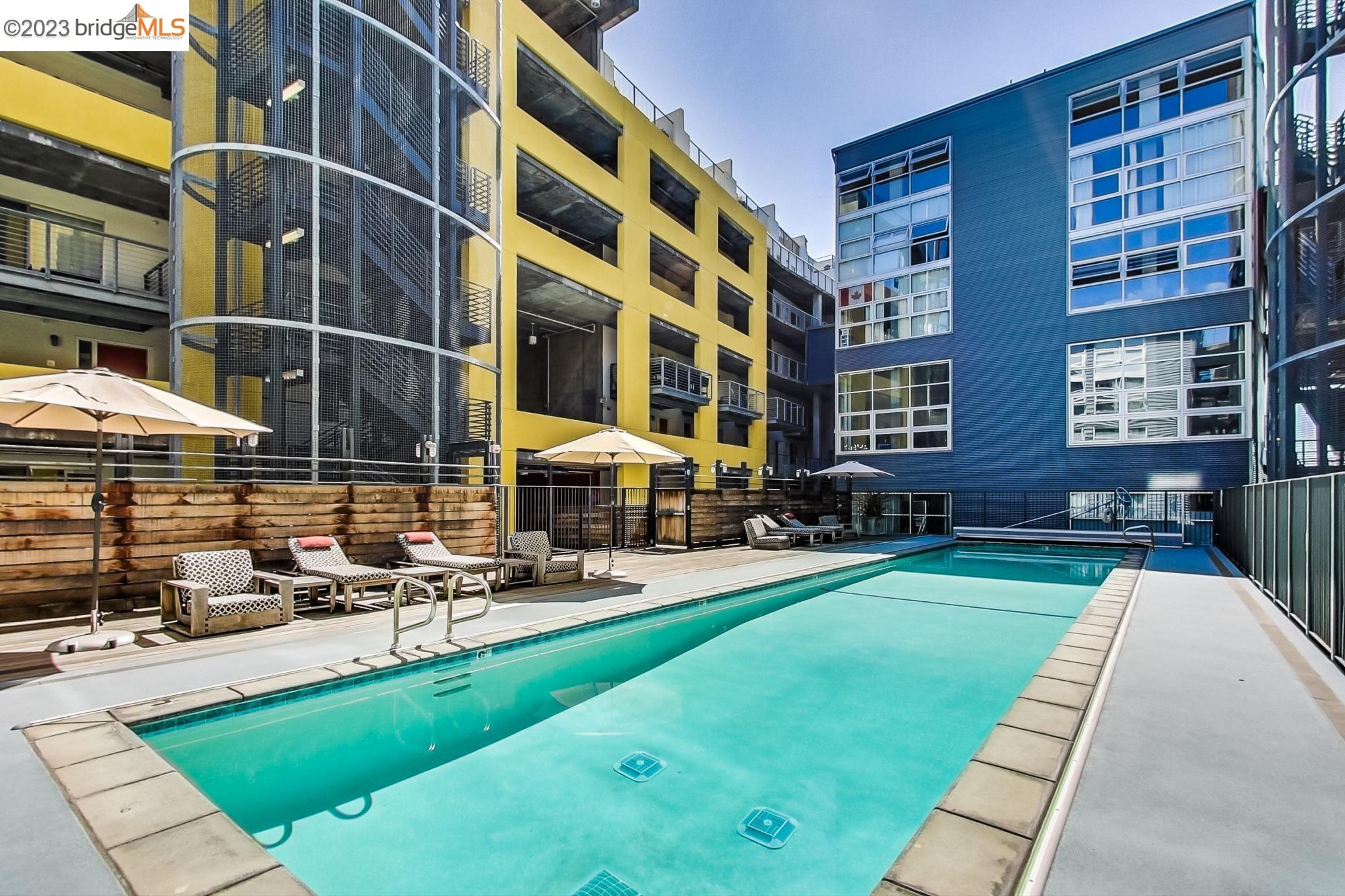 311 Oak Street, Unit 730 Oakland, CA 94607 - Photo 18 of 21 a building view with swimming pool and chairs