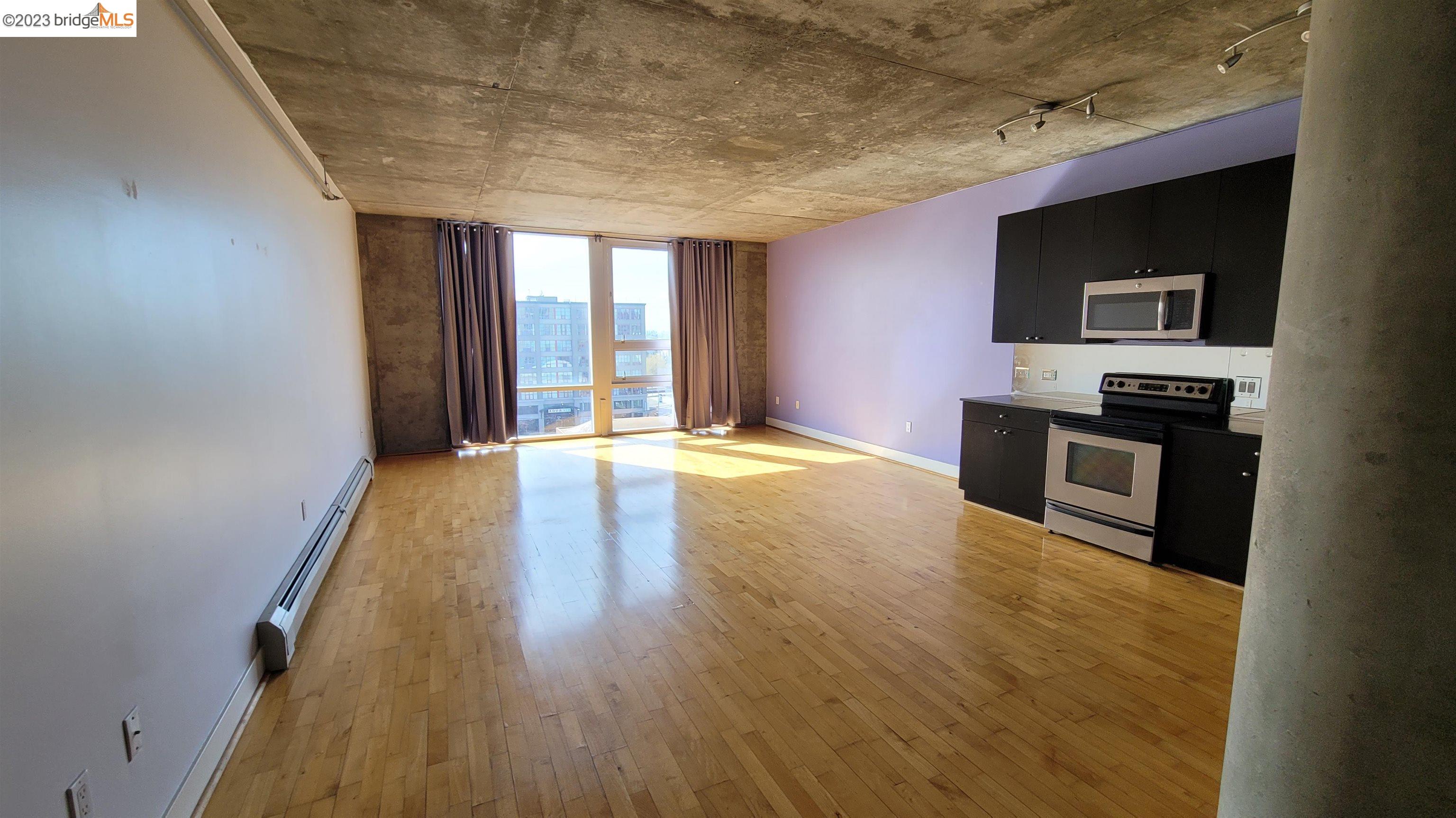 311 Oak Street, Unit 730 Oakland, CA 94607 - Photo 5 of 21 a view of a kitchen with a sink and a stove top oven