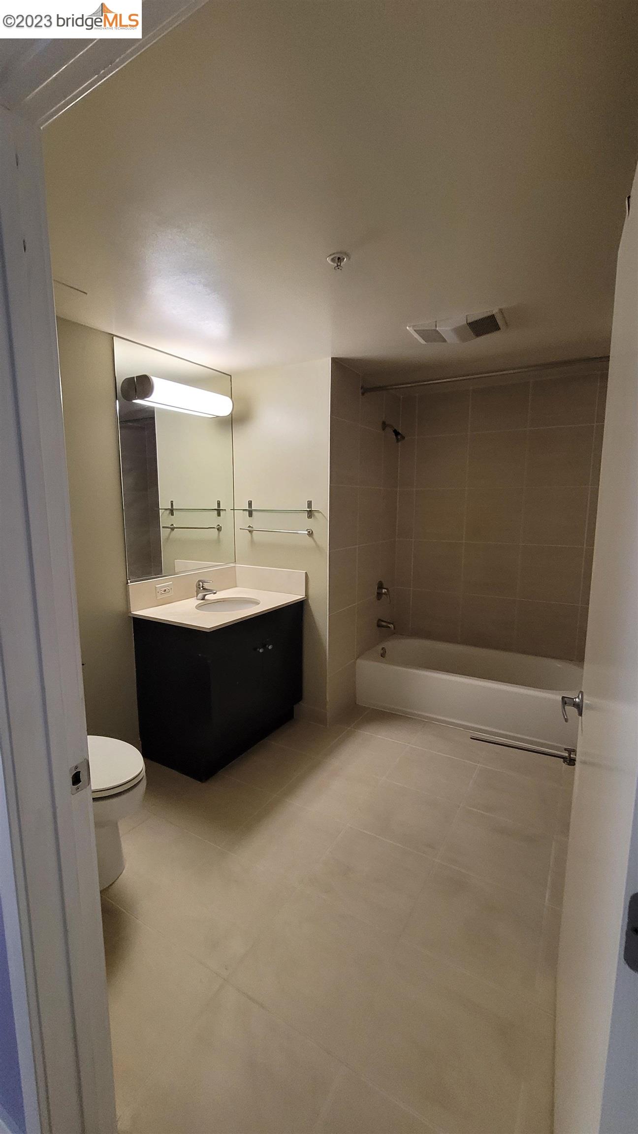 311 Oak Street, Unit 730 Oakland, CA 94607 - Photo 9 of 21 a bathroom with a sink a toilet and mirror