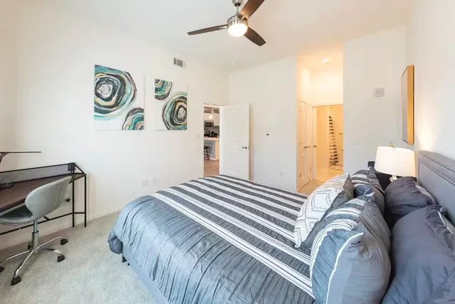 a bedroom with a bed and a chair