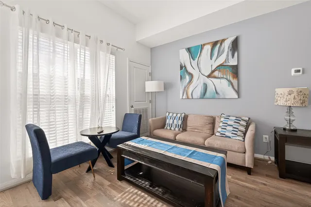 a living room with furniture and a large window