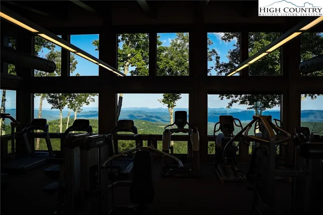 a dining room with furniture a chandelier and wooden floor