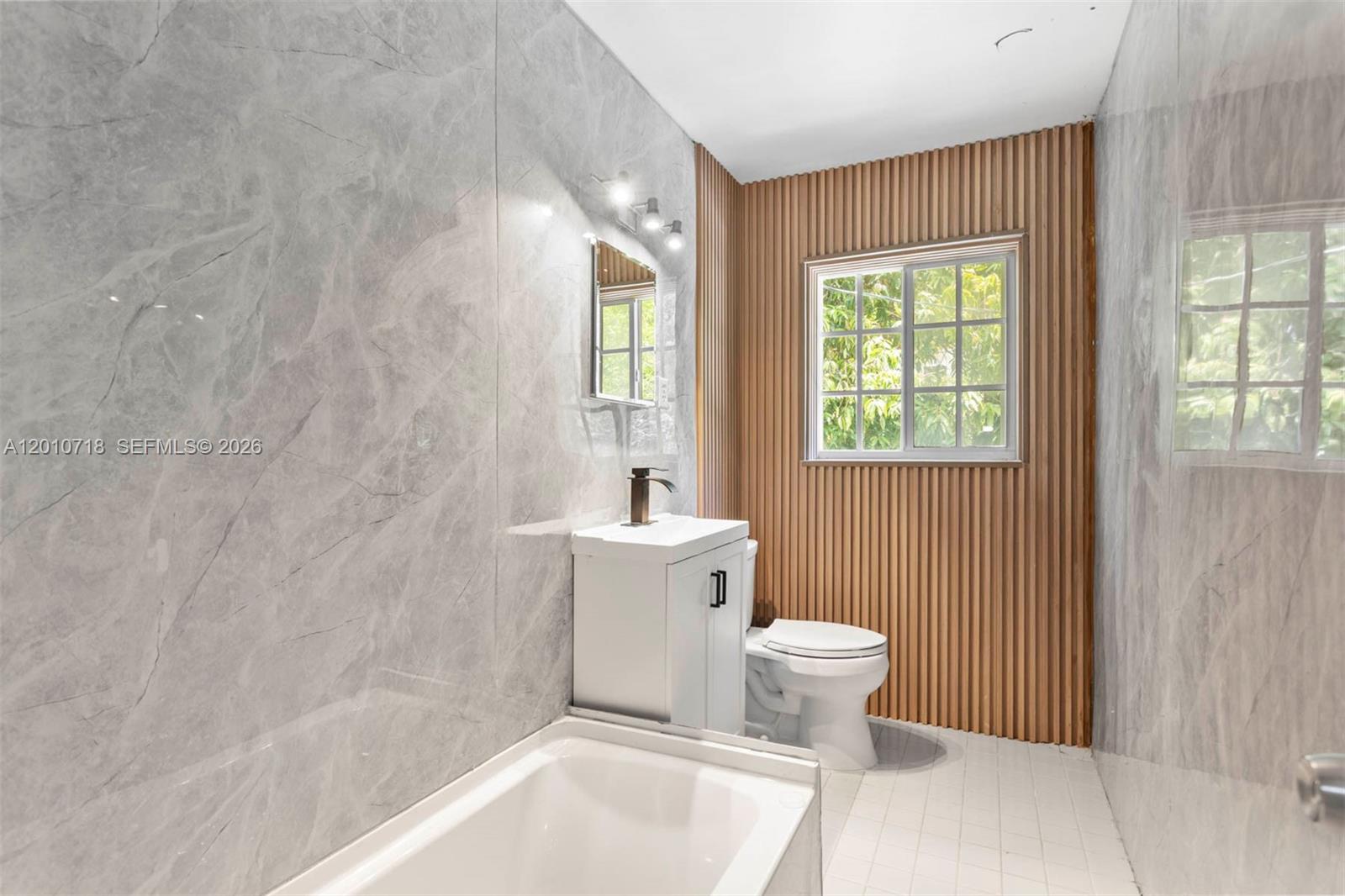 9125 Carlyle Avenue Surfside, FL 33154 - Photo 13 of 18 a bathroom with a sink toilet and shower