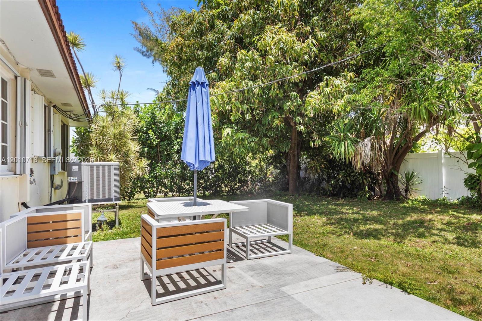 9125 Carlyle Avenue Surfside, FL 33154 - Photo 16 of 18 a view of a patio with a table and chairs