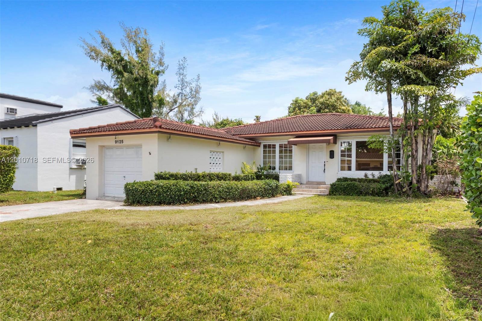 9125 Carlyle Avenue Surfside, FL 33154 - Photo 3 of 18 a view of a house with a yard and potted plants