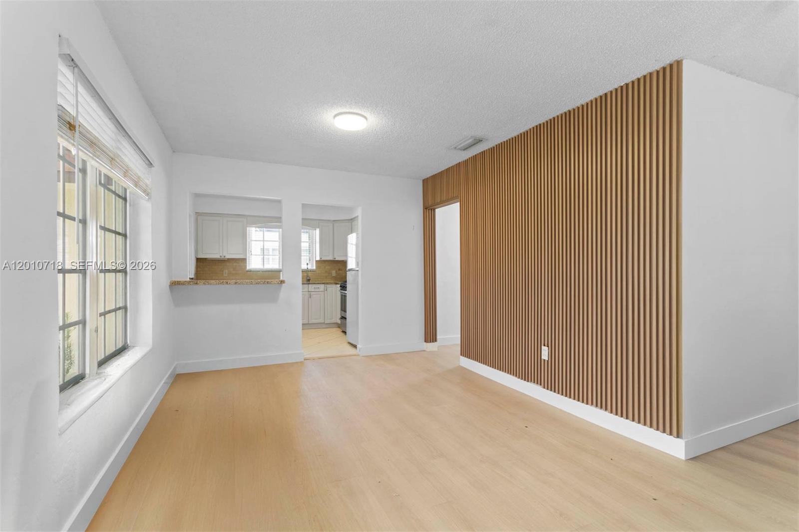 9125 Carlyle Avenue Surfside, FL 33154 - Photo 4 of 18 a view of an empty room with large windows