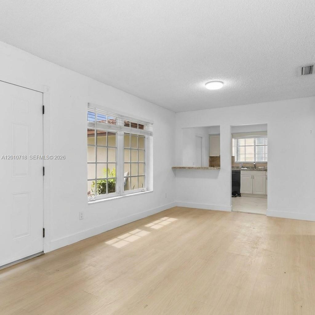 9125 Carlyle Avenue Surfside, FL 33154 - Photo 8 of 18 an empty room with windows and cabinet
