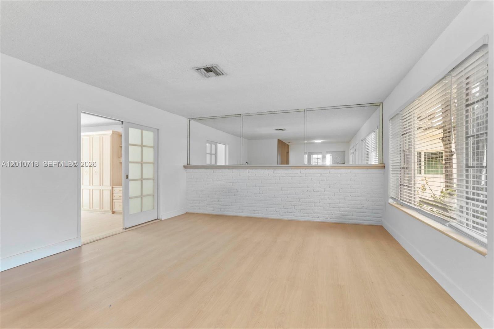 9125 Carlyle Avenue Surfside, FL 33154 - Photo 9 of 18 an empty room with windows