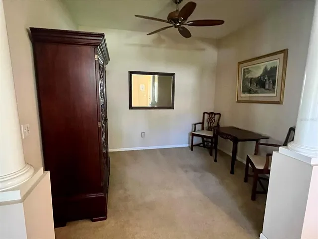 a view of a workspace with furniture and a window