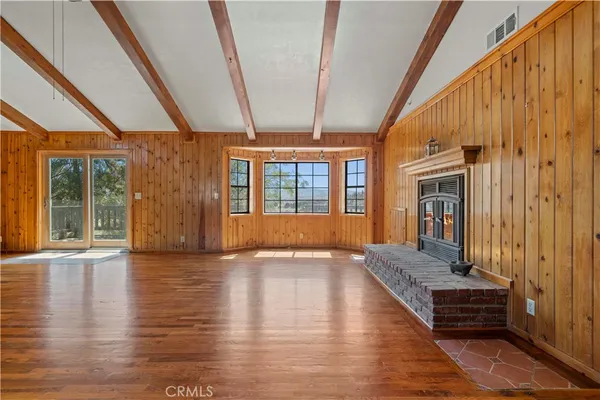 a view of an entryway with wooden floor and door
