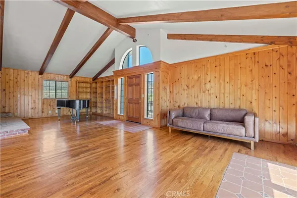 a view of living room with furniture and wooden floor