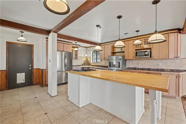 a kitchen with stainless steel appliances granite countertop a stove and a microwave