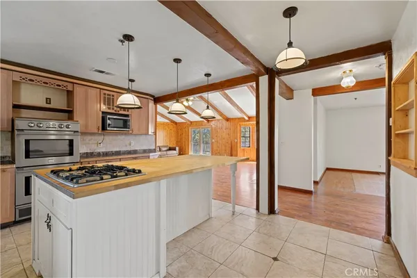 a kitchen with stainless steel appliances granite countertop a stove and a refrigerator