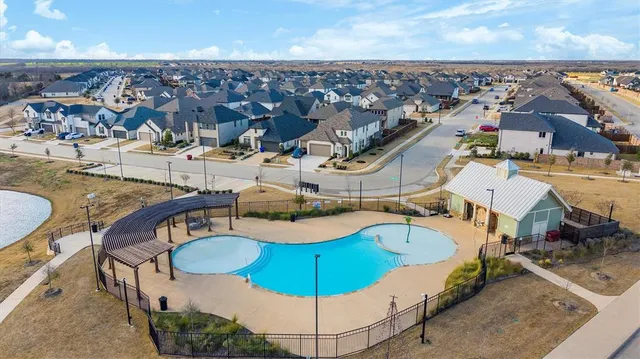 a view of a swimming pool with a yard