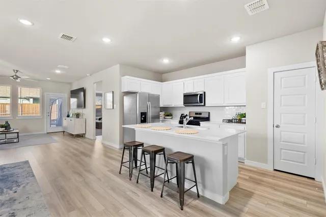 a work room with furniture a rug and a window