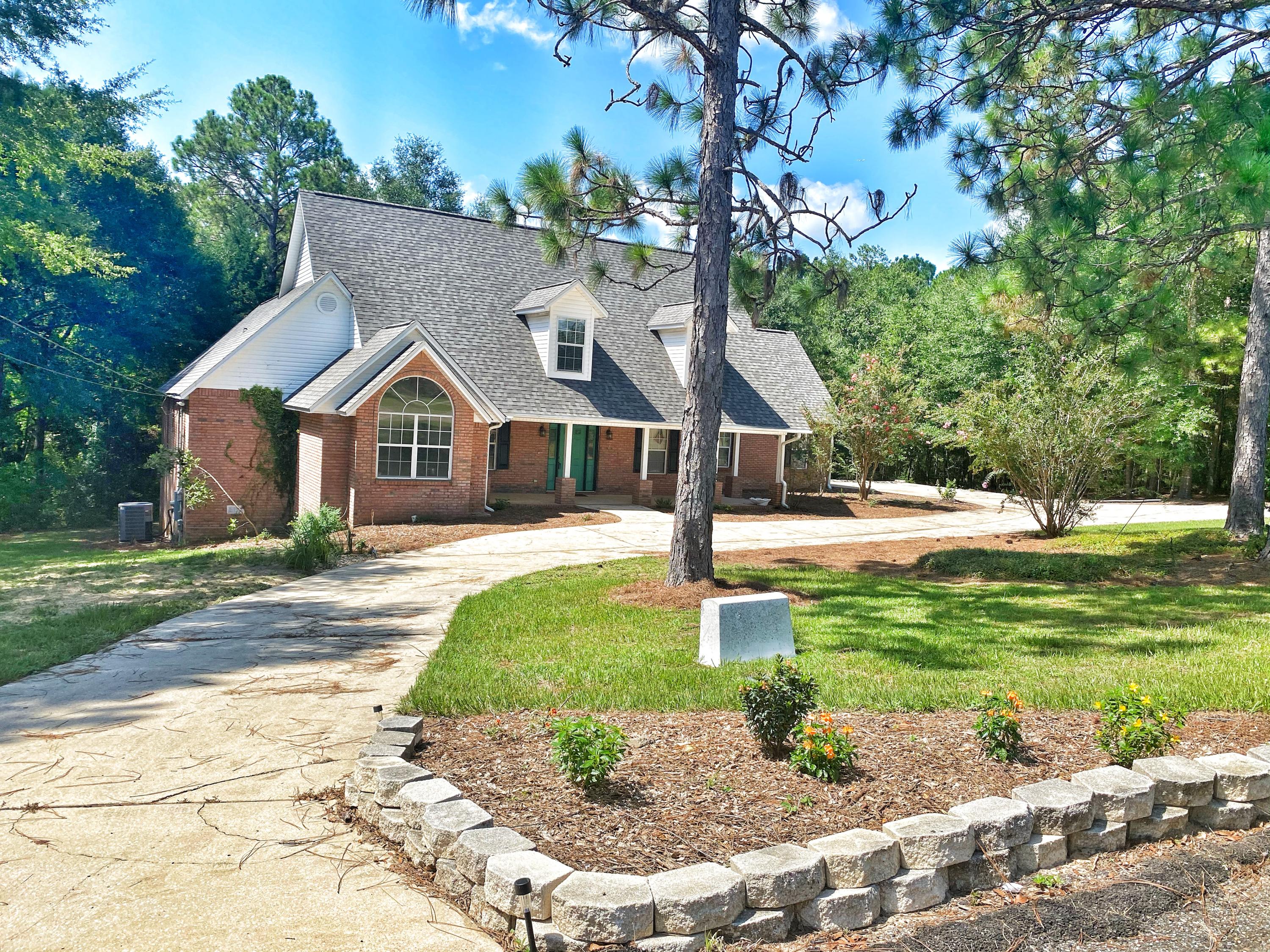 107 Blue Gill Way Crestview, FL 32539 - Photo 5 of 73 a front view of a house with a yard