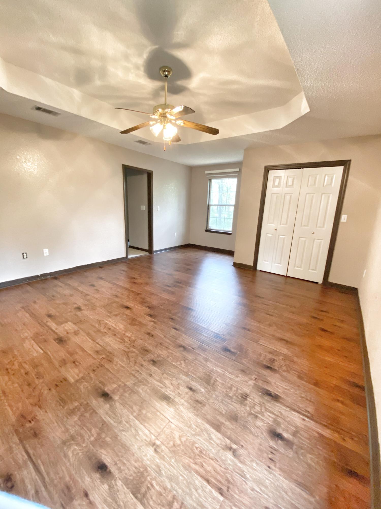 107 Blue Gill Way Crestview, FL 32539 - Photo 42 of 73 an empty room with wooden floor and windows
