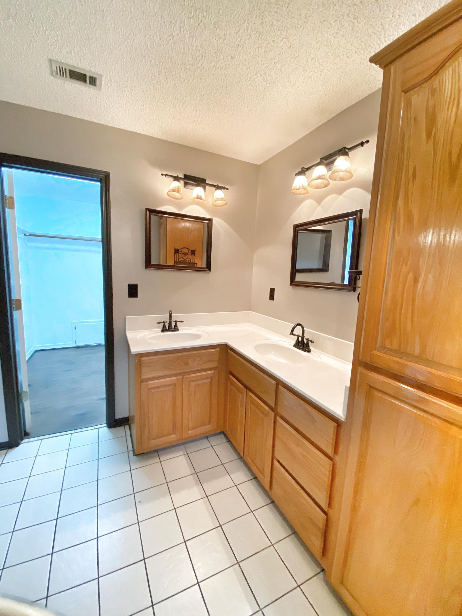 107 Blue Gill Way Crestview, FL 32539 - Photo 46 of 73 a spacious bathroom with a sink a mirror and a bathtub