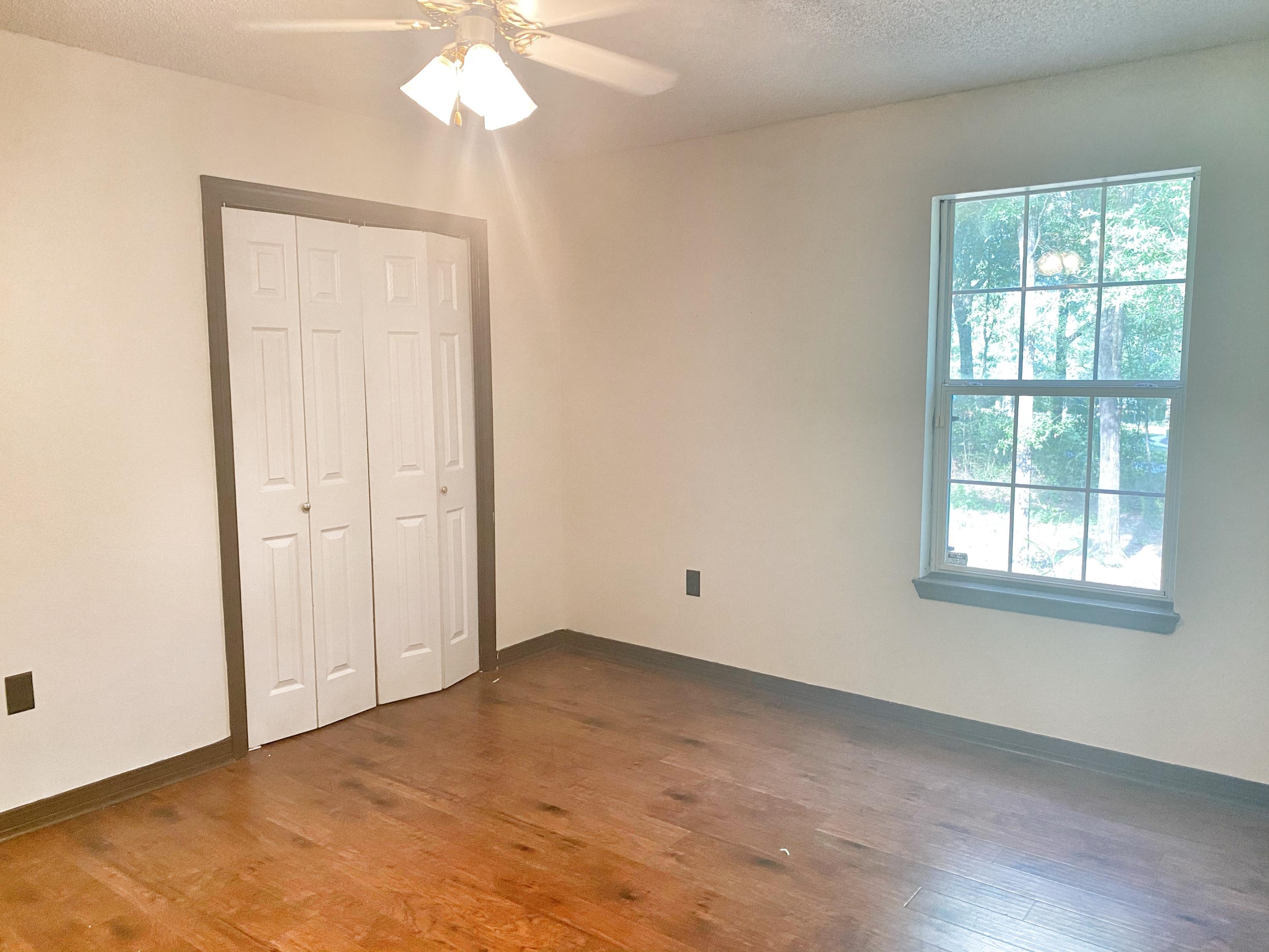 107 Blue Gill Way Crestview, FL 32539 - Photo 50 of 73 an empty room with chandelier fan and windows