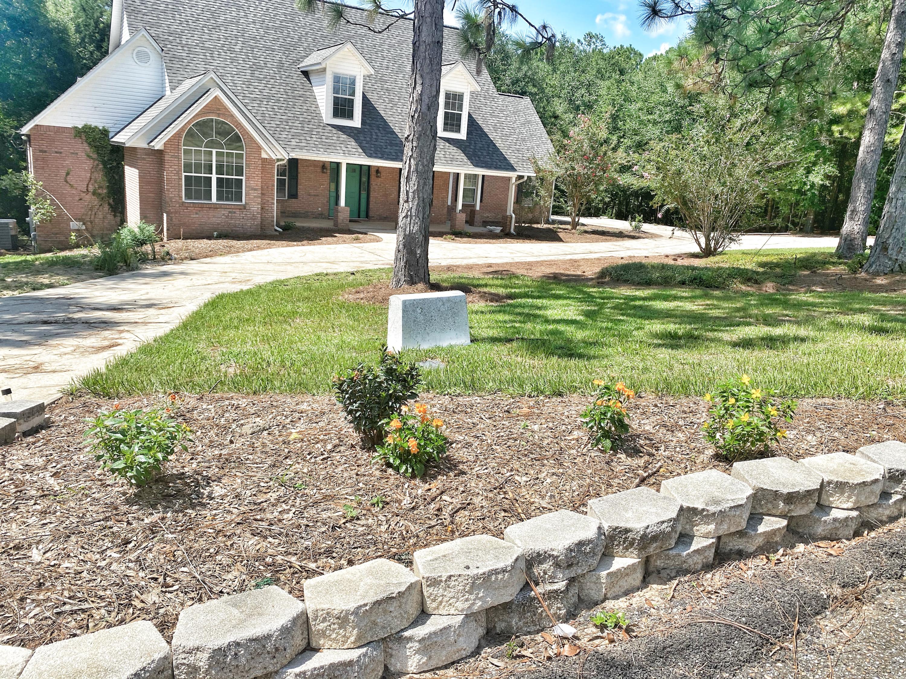 107 Blue Gill Way Crestview, FL 32539 - Photo 6 of 73 a front view of a house with garden