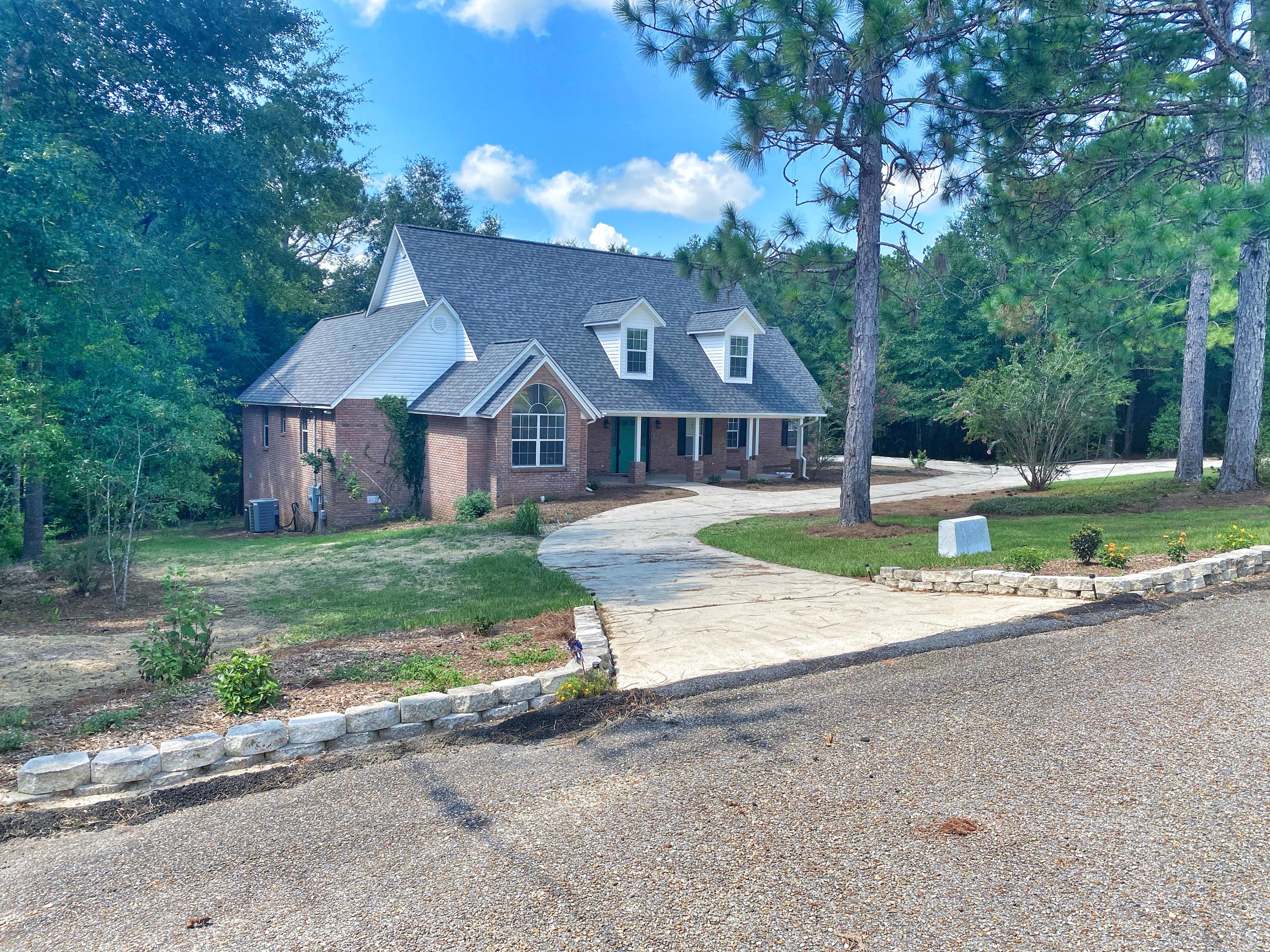107 Blue Gill Way Crestview, FL 32539 - Photo 7 of 73 a front view of a house with a yard and garage