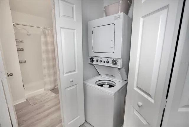 a room with furniture and view of kitchen