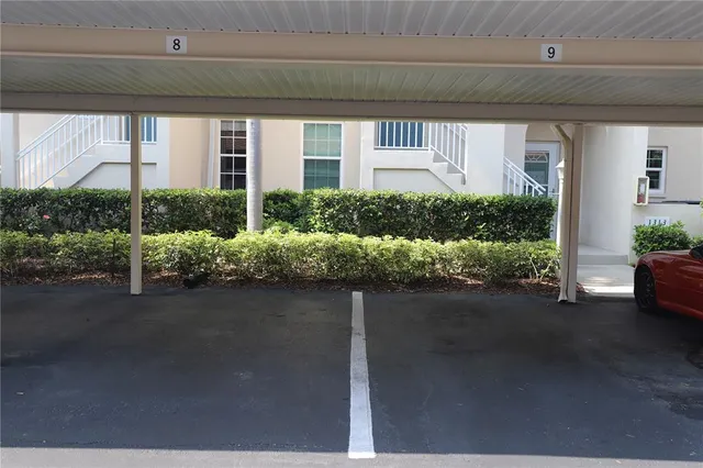 a living room with lots of furniture and a view of kitchen