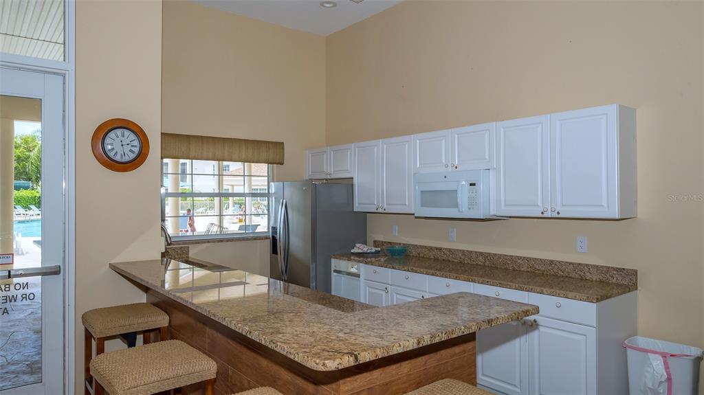 Undisclosed Address Sarasota, FL 34238 - Photo 33 of 56 a kitchen with granite countertop a stove a sink and a refrigerator