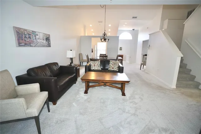 a living room with furniture and a lamp