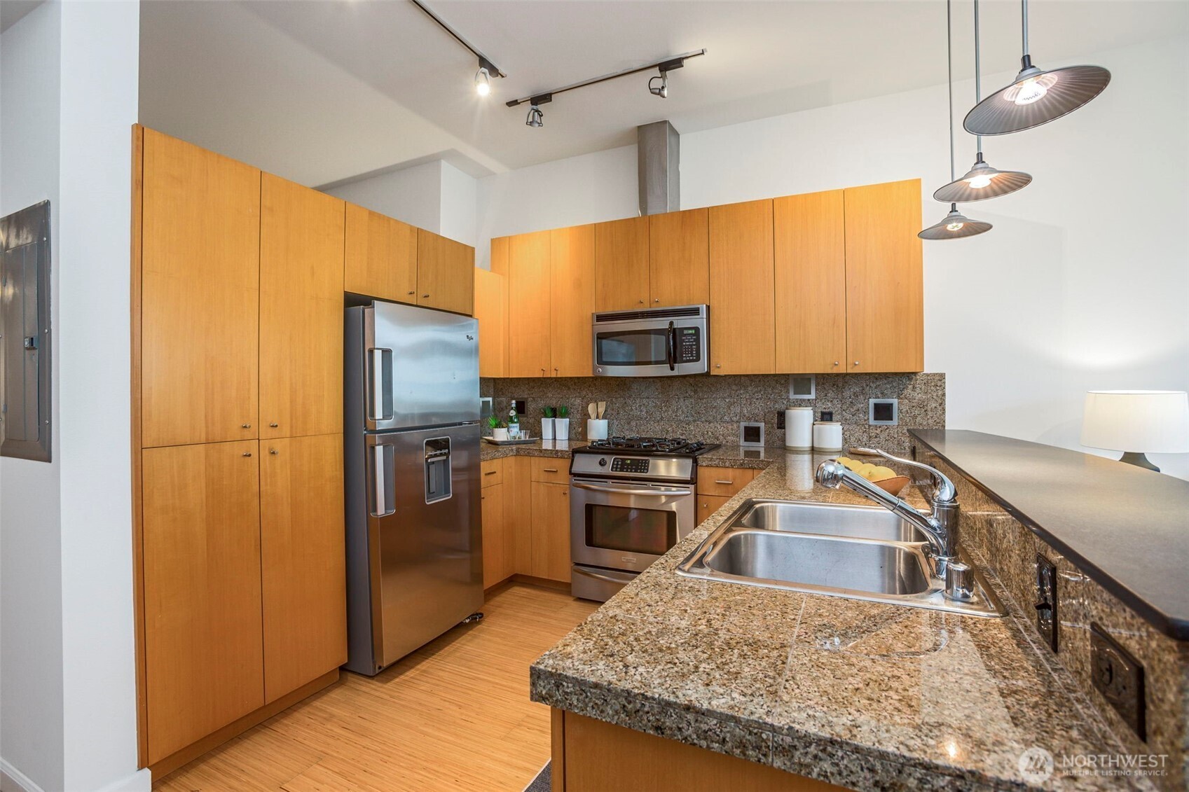 17 West Mercer Street, Unit 218 Seattle, WA 98119 - Photo 13 of 33 a kitchen with stainless steel appliances granite countertop a sink refrigerator and cabinets