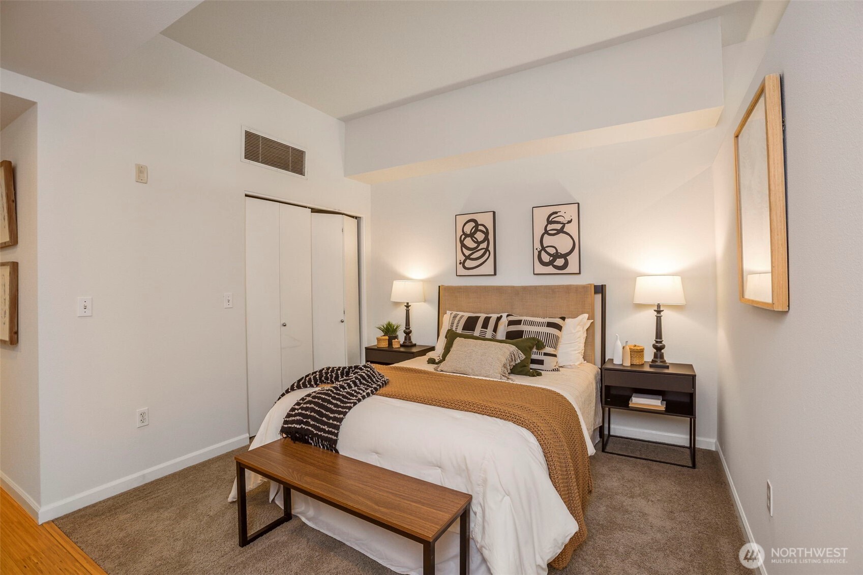 17 West Mercer Street, Unit 218 Seattle, WA 98119 - Photo 17 of 33 a bedroom with a bed and a lamp on table