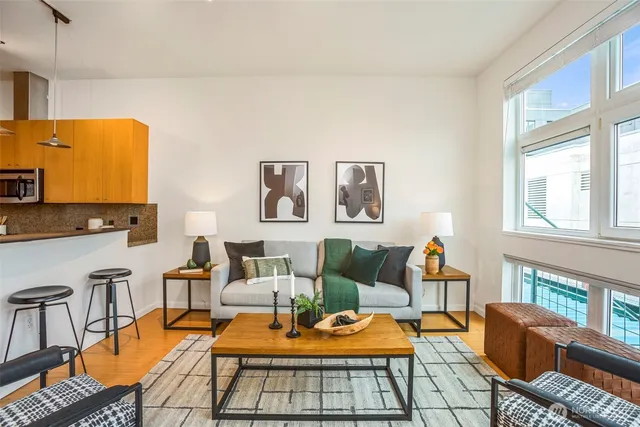 a living room with fireplace furniture and next to a window