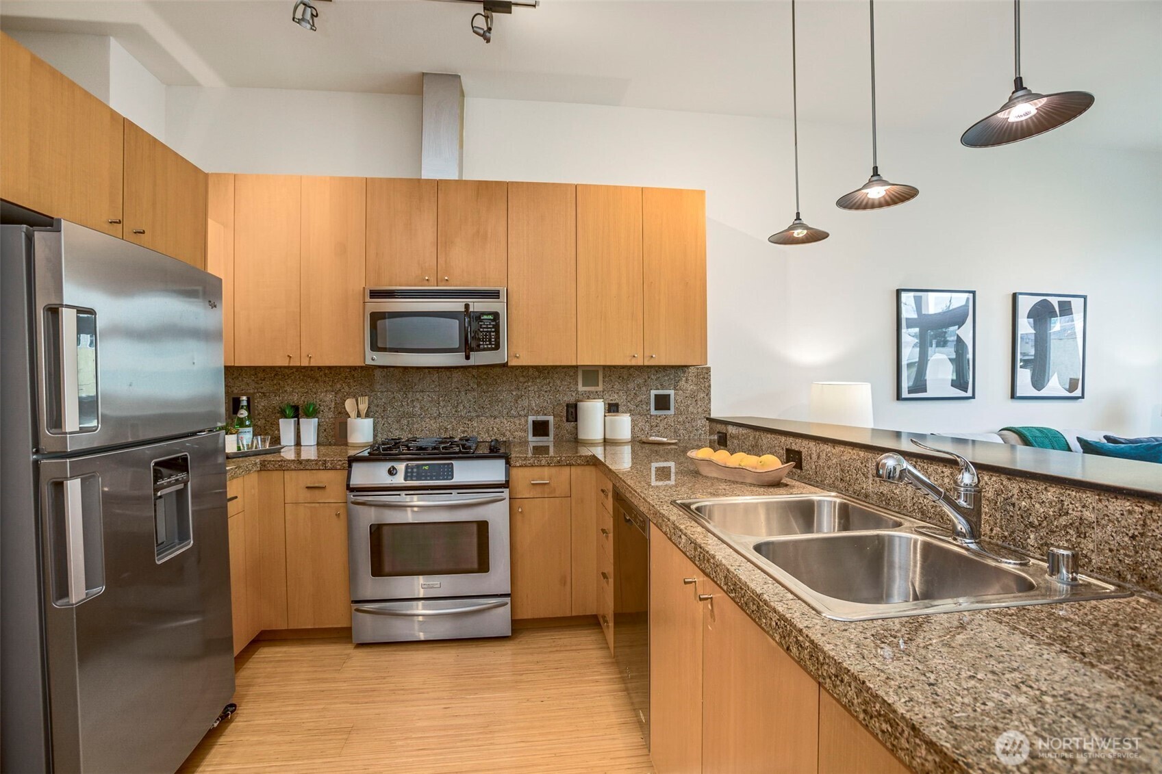 17 West Mercer Street, Unit 218 Seattle, WA 98119 - Photo 9 of 33 a kitchen with granite countertop a sink stainless steel appliances and cabinets