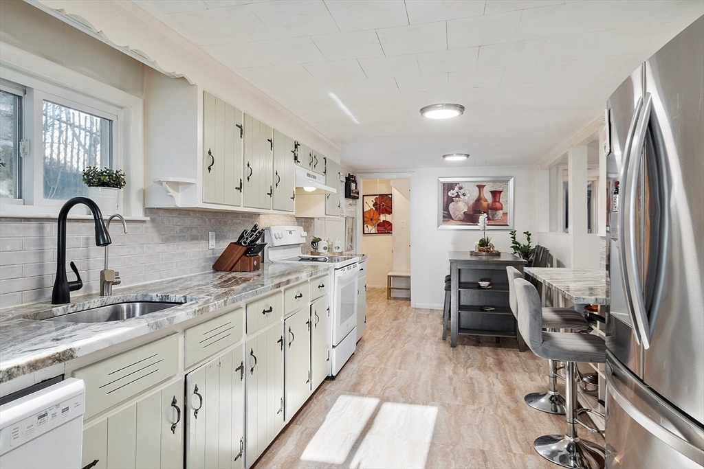 2 Grove Street Methuen, MA 01844 - Photo 11 of 38 a kitchen with granite countertop a sink appliances cabinets and counter space