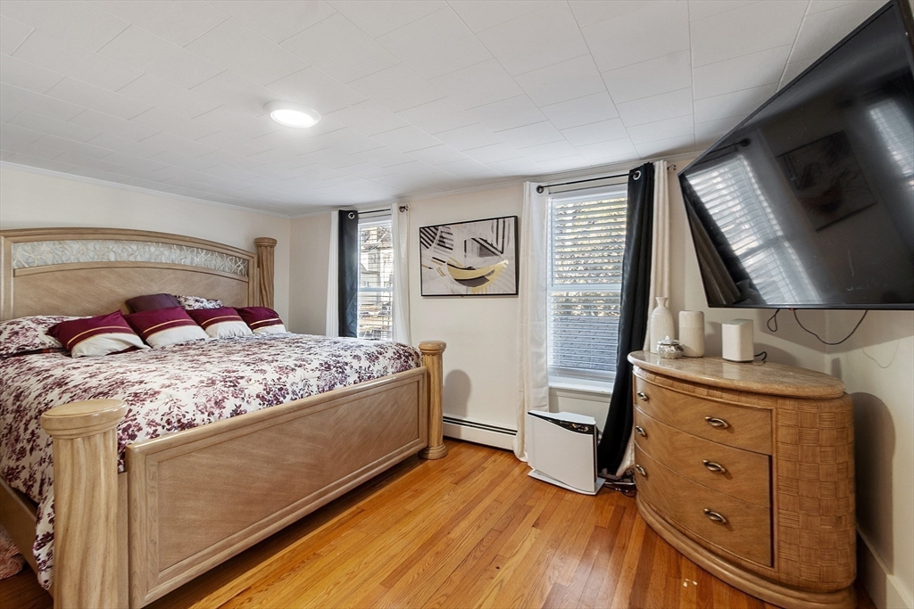 2 Grove Street Methuen, MA 01844 - Photo 18 of 38 a bedroom with a bed and a flat screen tv