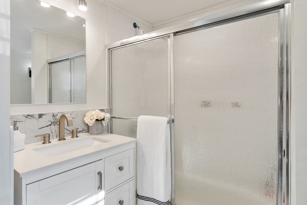 2 Grove Street Methuen, MA 01844 - Photo 23 of 38 a bathroom with a sink and a mirror