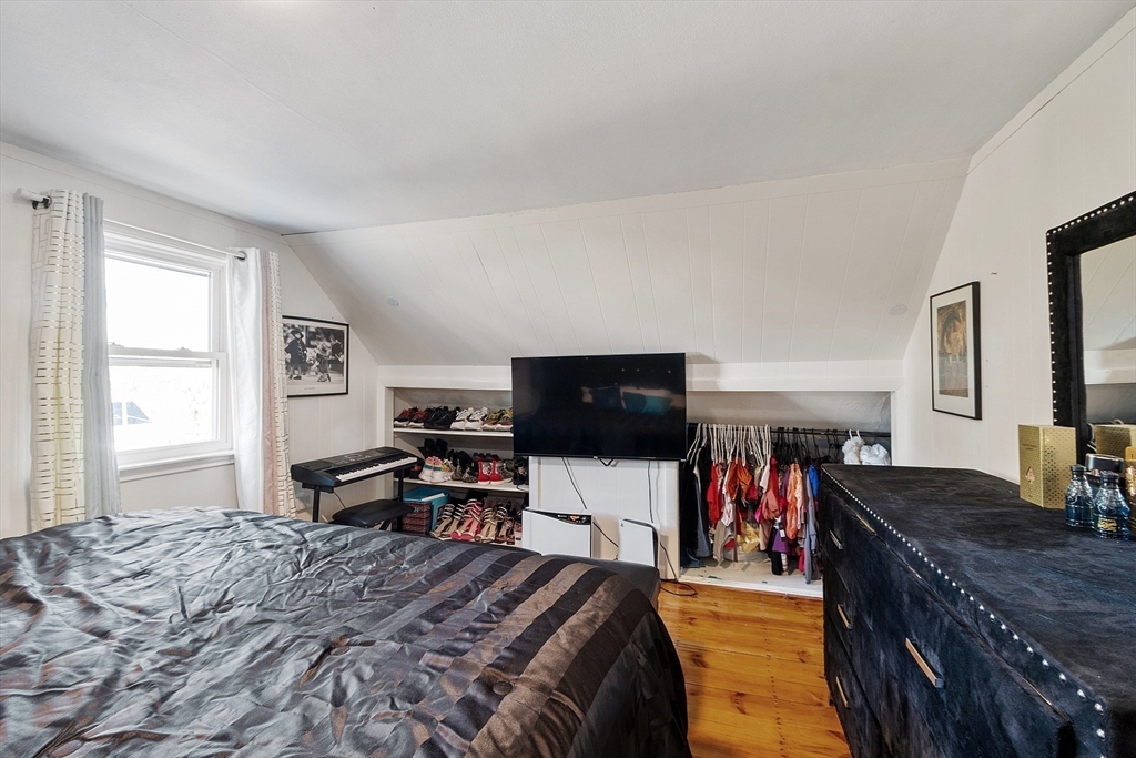 2 Grove Street Methuen, MA 01844 - Photo 24 of 38 a bedroom with a bed and a flat screen tv