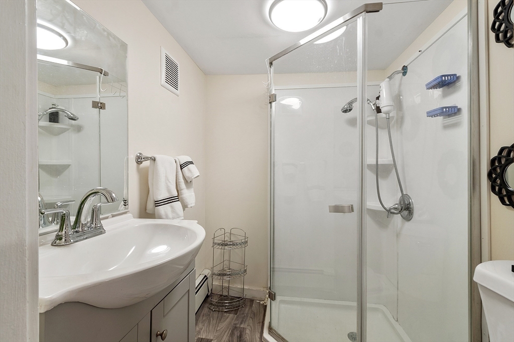 2 Grove Street Methuen, MA 01844 - Photo 30 of 38 a bathroom with a sink shower and a mirror