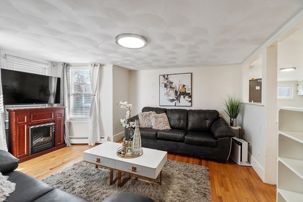 2 Grove Street Methuen, MA 01844 - Photo 6 of 38 a living room with furniture and a flat screen tv