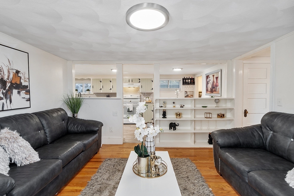 2 Grove Street Methuen, MA 01844 - Photo 7 of 38 a living room with furniture and a chandelier