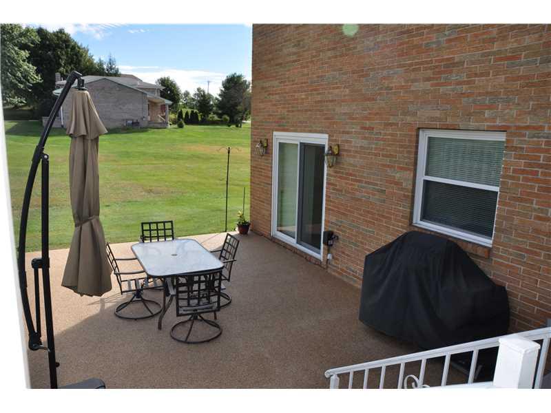 210 Edgewood Road Beaver Falls, PA 15010 - Photo 20 of 25 Exterior Front. View from upper level of porch to your lower level patio .. also covered in nature stone .. notice the sliding doors - these are located in your family room
