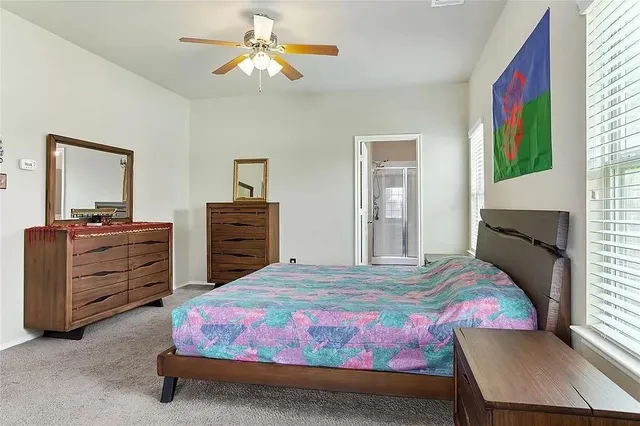 a bedroom with a bed and a dresser in it