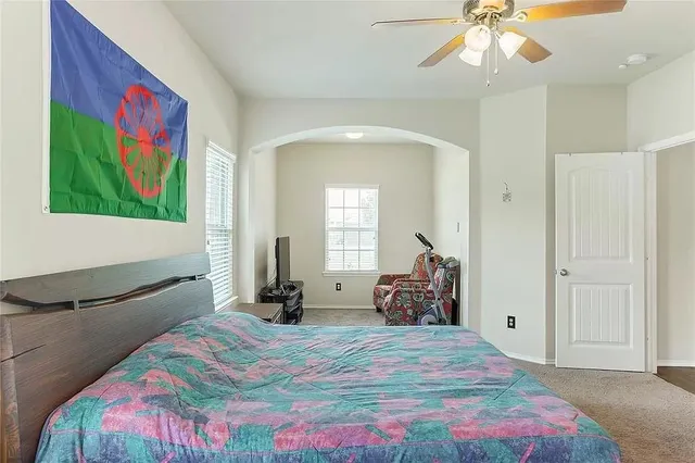 a bedroom with a bed and a chandelier