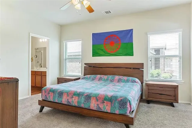 a bedroom with a bed a dresser and a window