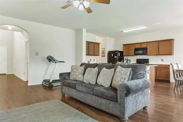 a living room with furniture gym equipment and a flat screen tv